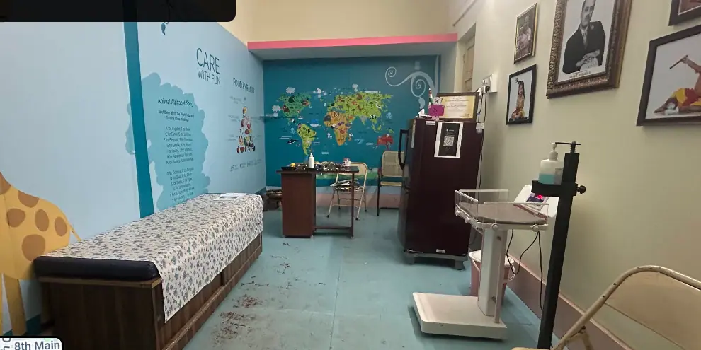 Consultation room with examination bed and wall mural